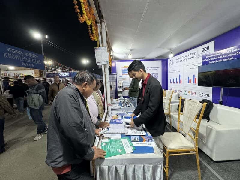 Darshan Saikia talking with visitors at the investor awareness stall, Assam Book Fair