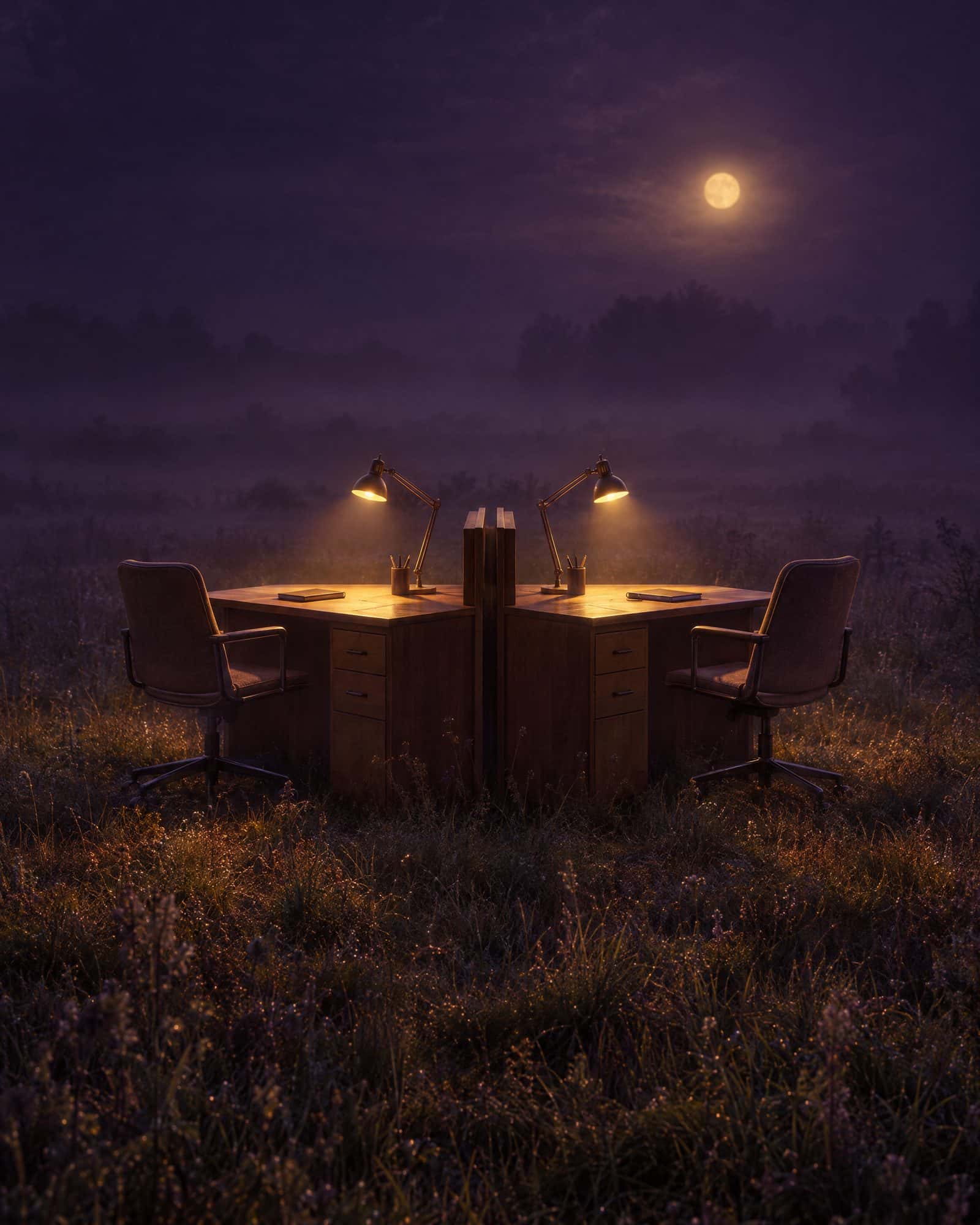 Two desks back to back in a misty field at night, each lit by its own lamp.